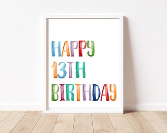 May include: A white framed print with the words "Happy 13th Birthday" in colorful watercolor lettering.
