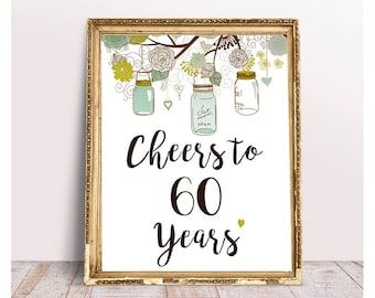 May include: A gold framed printable sign with a white background and a floral design. The sign says "Cheers to 60 Years".