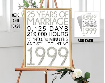 May include: A white sign with a gold frame on an easel with the text "25 Years of Marriage 9,125 Days 219,000 Hours 13,140,000 Minutes And Still Counting 1999". A smaller card with the same text is also shown.