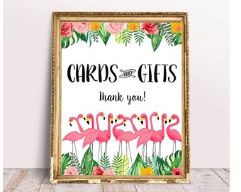 May include: A printable sign with a gold frame and a white background. The sign says "Cards & Gifts" with a pink flamingo illustration. The sign is decorated with tropical flowers and leaves.