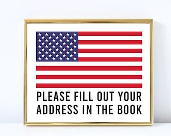 May include: A gold framed print with an American flag and the text "PLEASE FILL OUT YOUR ADDRESS IN THE BOOK".