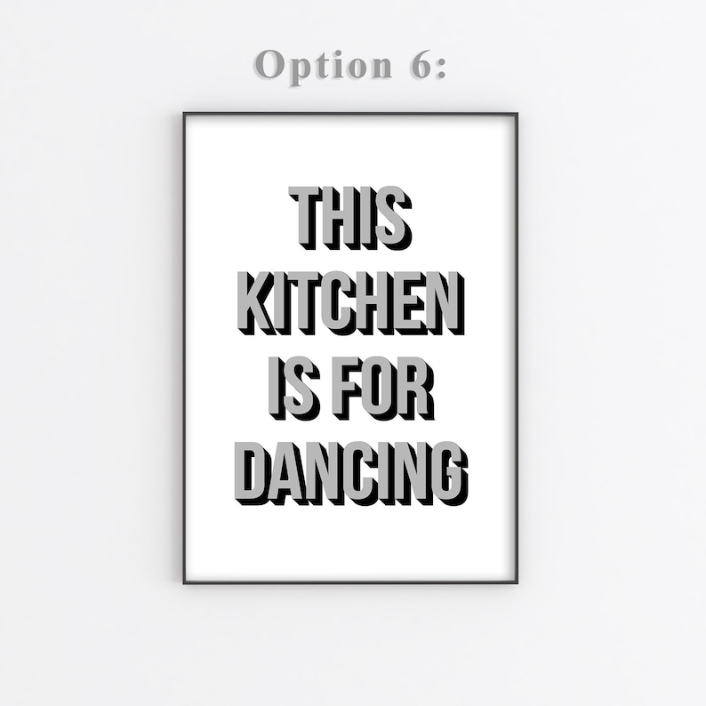 May include: A black and white framed print with the text "This kitchen is for dancing" in a bold, 3D-style font.
