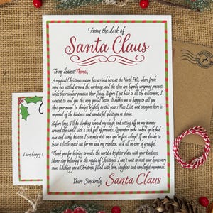 Peut inclure: Une lettre blanche du P&egrave;re No&euml;l avec une bordure ray&eacute;e rouge et verte. Le texte indique : From the desk of Santa Claus, To my dearest Thomas, A magical Christmas season has arrived here at the North Pole, et Yours Sincerely, Santa Claus.