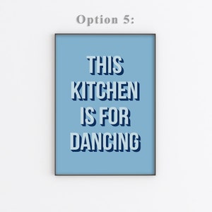 May include: A light blue poster with black text that reads "This Kitchen Is For Dancing".
