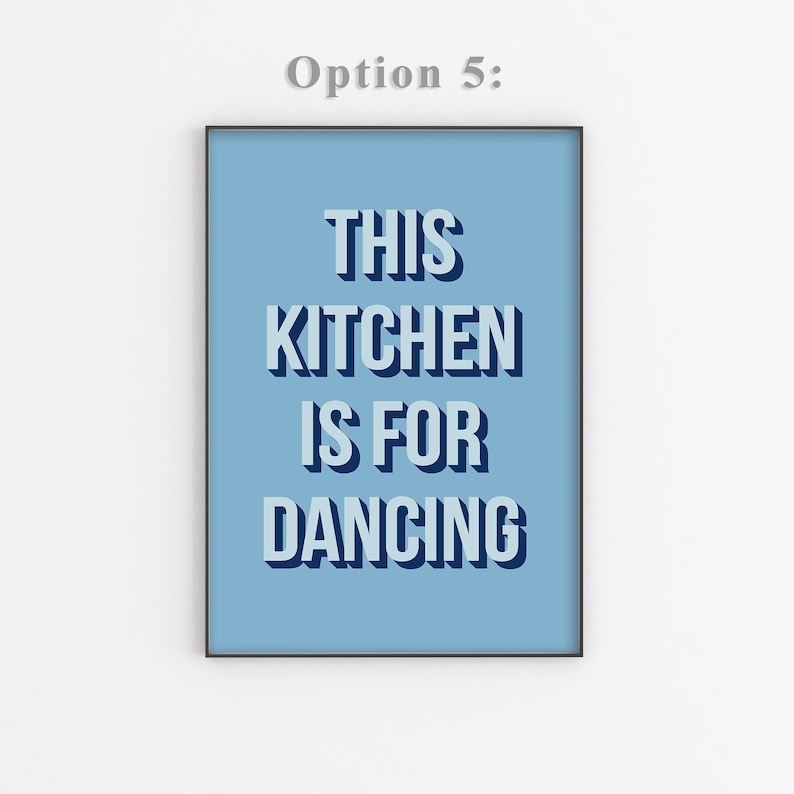 May include: A light blue poster with black text that reads "This Kitchen Is For Dancing".
