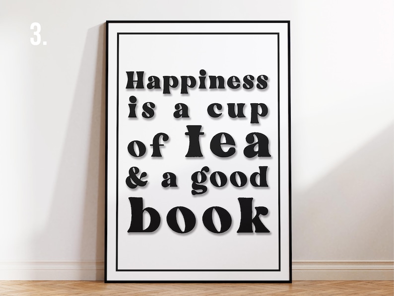 May include: Black and white typography print with the text "Happiness is a cup of tea & a good book".