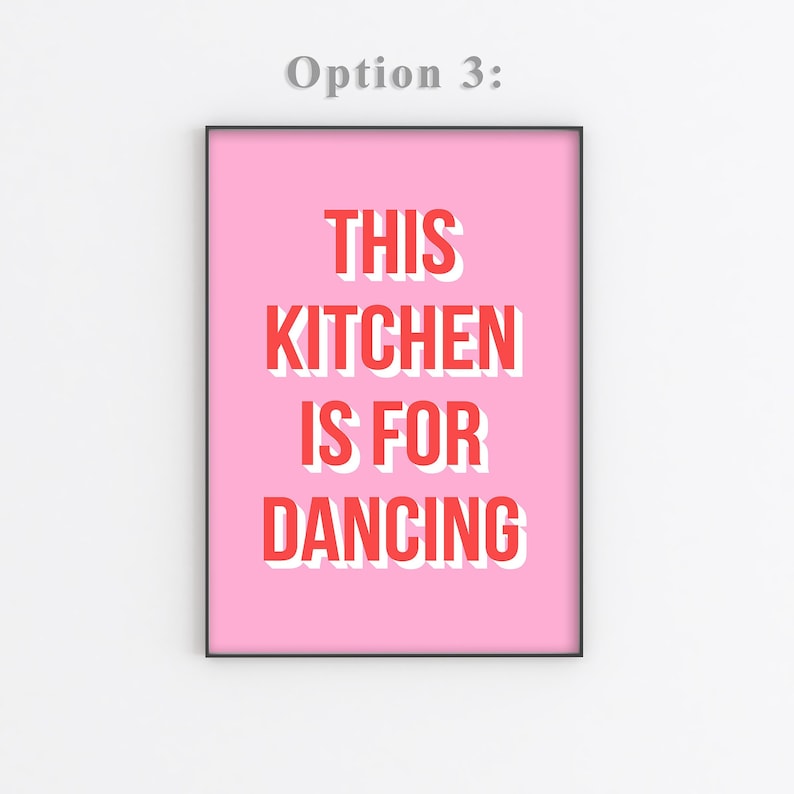 May include: Pink printable wall art with the text "This Kitchen is for Dancing" in red with a white outline.