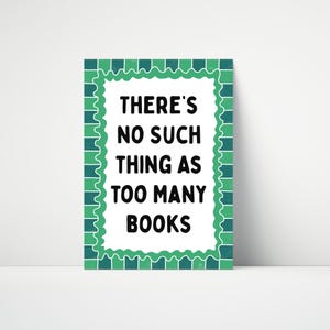 May include: A rectangular sign with a white background and a green scalloped border. The text "THERE'S NO SUCH THING AS TOO MANY BOOKS" is in bold black font. The sign is a decorative item.