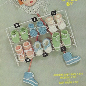 May include: A vintage knitting pattern booklet for baby booties. The cover features a doll wearing a crocheted bonnet and holding a pair of booties. The pattern is for Sirdar Sunshine Series No. 122 and costs 6 pence. The pattern uses Sunshine Baby Wool 3 ply, Majestic 3 ply, or Baby Nylon 3 ply.