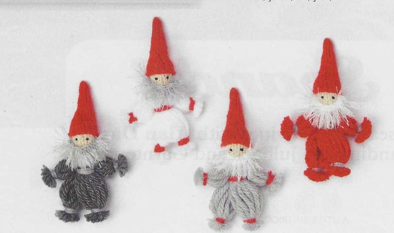 May include: Four handmade gnome figurines with red pointed hats, white beards, and various colored outfits. The gnomes are made of yarn and have small, detailed features, perfect for holiday decor.