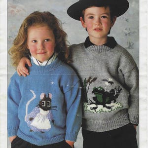 May include: A Patons Double Knitting pattern C 4302 for 22-30 inch sizes. The cover features a light blue jumper with a mouse graphic and a grey jumper with a frog graphic, both with ribbed necklines, cuffs, and hems, worn by two children.