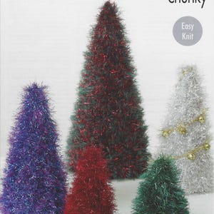 May include: A selection of tinsel Christmas trees in shades of purple, red, green, and silver. The trees are conical and have a fluffy, textured appearance. The image also features the text "tinsel chunky" and "Easy Knit".
