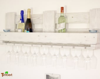 Vintage wine rack in shabby chic white made from recycled Euro pallets. Pallet furniture, wall shelf for wine bottles with glass holders, wooden shelf.