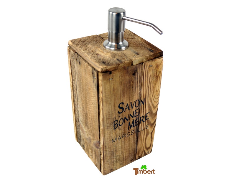 May include: A wooden soap dispenser with a stainless steel pump. The dispenser is made from reclaimed wood and has the text "Savon Bonne Mere Marseille" printed on the front.