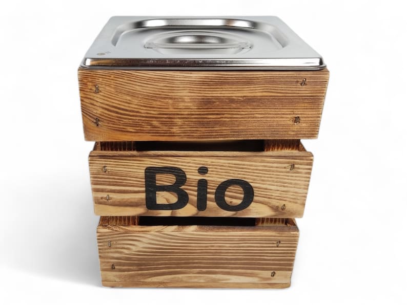 May include: A wooden compost bin with a stainless steel liner. The bin has the word "Bio" printed on the front.