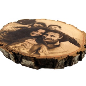May include: A wood slice with a black and white photo of a family of four. The photo is burned into the wood.