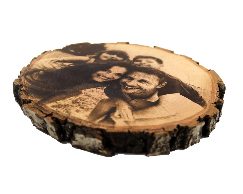 May include: A wood slice with a black and white photo of a family of four. The photo is burned into the wood.