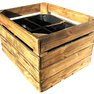 May include: A rustic wooden crate with a divided interior, perfect for planting herbs. The crate is stained a light brown color and has the words "Jardin d'Herbes" engraved on the side.