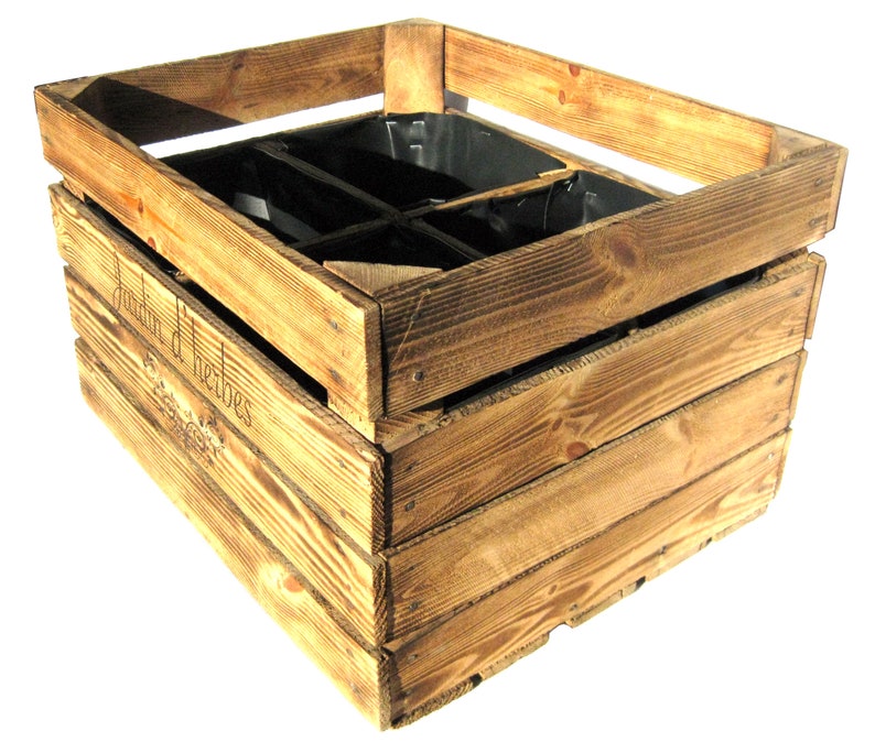 May include: A rustic wooden crate with a divided interior, perfect for planting herbs. The crate is stained a light brown color and has the words "Jardin d'Herbes" engraved on the side.