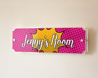 May include: A pink and yellow door sign with white polka dots and a white comic book style speech bubble that says "Jenny's Room".