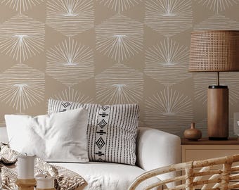 May include: A living room scene featuring a white sofa with decorative pillows and a patterned throw. A round coffee table holds candles and a vase. A rattan chair and a wooden lamp with a woven shade add to the cozy, neutral-toned decor.
