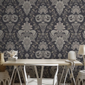 May include: A black and white damask patterned wallpaper with a gold sheen. The wallpaper is in a home office setting with a white desk, chair, and decorative items.