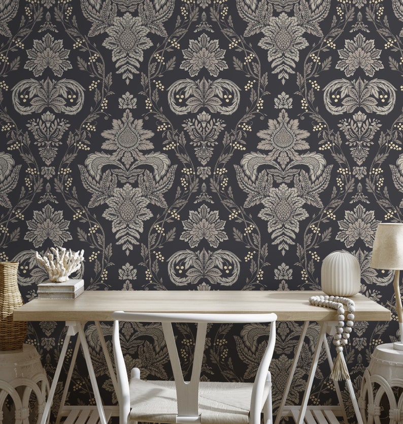 May include: A black and white damask patterned wallpaper with a gold sheen. The wallpaper is in a home office setting with a white desk, chair, and decorative items.
