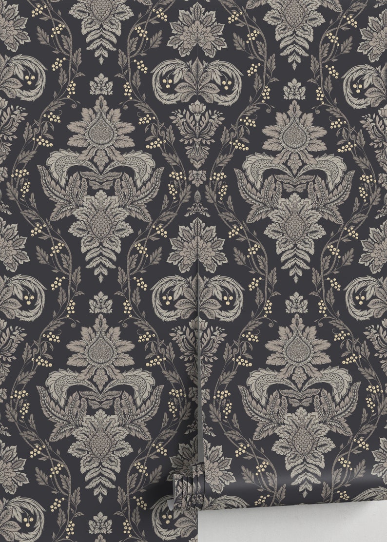 May include: Black wallpaper with a repeating pattern of gold and gray floral damask designs. The wallpaper is rolled up and partially unrolled, showing the pattern.