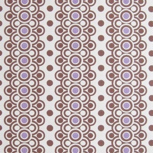 May include: A white fabric with a repeating pattern of brown and purple circles. The circles are arranged in vertical rows, with each row offset from the one above it. The pattern is reminiscent of a retro design.