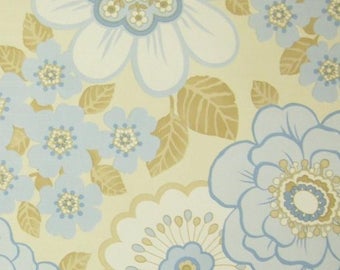 May include: A vintage wallpaper pattern with a light yellow background and blue and brown floral designs. The flowers are stylized and have a retro look.