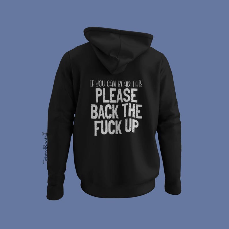 A black hoodie with white text on the back, which reads "IF YOU CAN READ THIS PLEASE BACK THE F*CK UP".