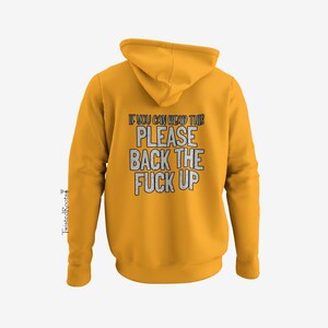 A yellow hoodie with the text "IF YOU CAN READ THIS PLEASE BACK THE F*CK UP" printed on it.