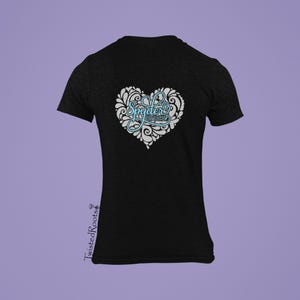 May include: Black t-shirt with a white heart design featuring the text "Spyder Ryder" in blue.