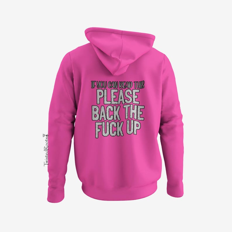 A bright pink hoodie with the text "IF YOU CAN READ THIS PLEASE BACK THE F*CK UP" printed on it.