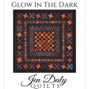 May include: A quilt pattern called "Glow in the Dark" by Jen Daly Quilts. The quilt features a black background with a checkerboard pattern in the center surrounded by a border of orange and purple stars and triangles.