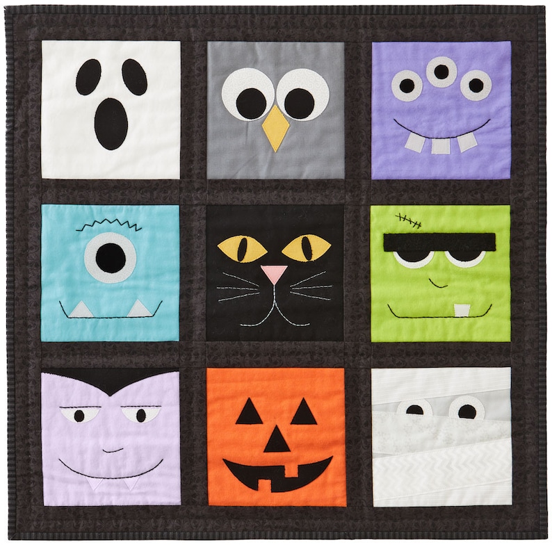 May include: A Halloween-themed quilt featuring nine square blocks, each with a different monster face. The faces include a ghost, owl, three-eyed monster, one-eyed monster, black cat, Frankenstein, vampire, jack-o'-lantern, and mummy. The quilt is bordered in a dark gray fabric.