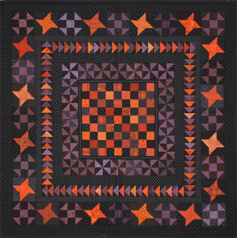 May include: A quilt with a checkerboard pattern in the center surrounded by a border of purple, orange, and black stars. The quilt is made of various fabrics with different patterns and textures.