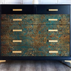 A vintage 6-drawer dresser is painted dark blue and features the Aged Patina A1 Fiber paper on it's bottom 4 drawers.