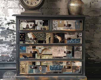 May include: A dark gray dresser with five drawers, each adorned with a collage of vintage-style papers and images. The dresser features bronze-colored hardware and sits beneath a large clock. The bottom of the dresser has the text "#675097 mystic manuscripts".