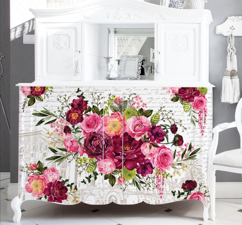 A large white dresser buffet that has the royal burgundy transfer across the front.