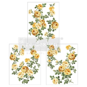May include: Three floral transfer sheets featuring yellow roses and green leaves on a white background. The roses have a vintage, watercolor style. The text "re design" is partially visible on the top sheet.