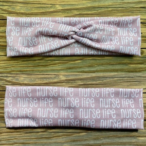 May include: A pink headband with the words "nurse life" repeated in white text.