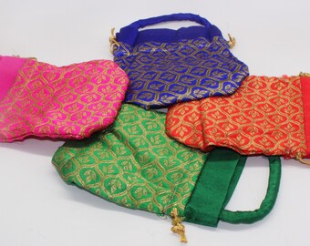 May include: Four small drawstring bags with handles. The bags are made of a patterned fabric with gold accents. The bags are in the colors blue, pink, green, and red.