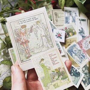 May include: A hand holding a stack of vintage-style art cards with illustrations and text. The cards feature images of people, flowers, and text. The color palette includes soft greens, pinks, and creams, with a focus on Art Nouveau aesthetics.