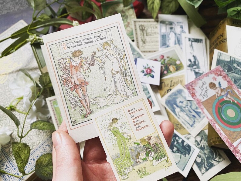 May include: A hand holding a stack of vintage-style art cards with illustrations and text. The cards feature images of people, flowers, and text. The color palette includes soft greens, pinks, and creams, with a focus on Art Nouveau aesthetics.