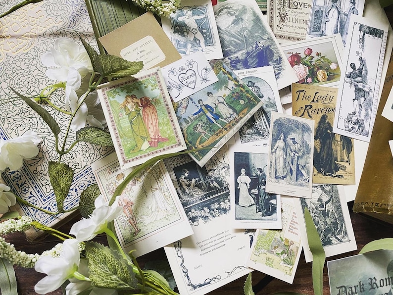May include: A collection of vintage-style postcards and ephemera, featuring illustrations and text. The cards are scattered among white floral accents and a patterned book. The color palette includes greens, blues, and creams.