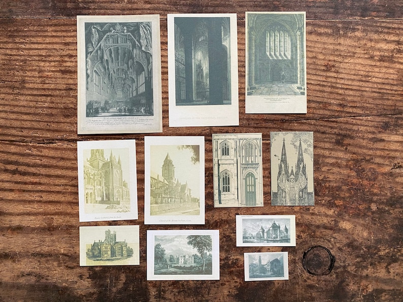 K&ouml;nnte beinhalten: Eine Sammlung von Vintage-Architektur-Drucken, die detaillierte Illustrationen von Kathedralen, Kirchen und anderen historischen Geb&auml;uden zeigen. Die Drucke sind in Grau- und Gr&uuml;nt&ouml;nen gehalten und auf einer rustikalen Holzoberfl&auml;che angeordnet.