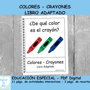 May include: A colorful educational book for special education students. The cover features a spiral bound book with the title "Colores - Crayones Libro Adaptado" and the question "¿De qué color es el crayón?"  The book includes three crayons, one red, one green, and one blue.