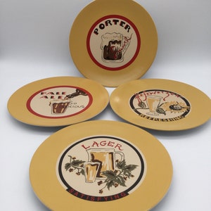 May include: Four yellow ceramic plates with beer-themed designs. Each plate features a different beer style: Porter, Pale Ale, Lager, and Hefeweizen. The plates have red and black text and illustrations of beer mugs.