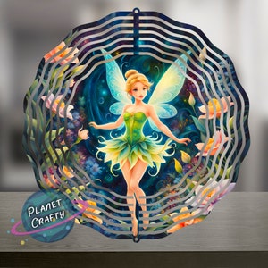 May include: A metal wind spinner with a fairy design. The fairy is green and has wings. The background is a dark blue with stars and flowers.
